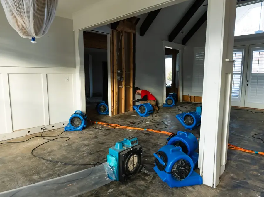 A restoration technician setting drying equipment in a Pasadena home