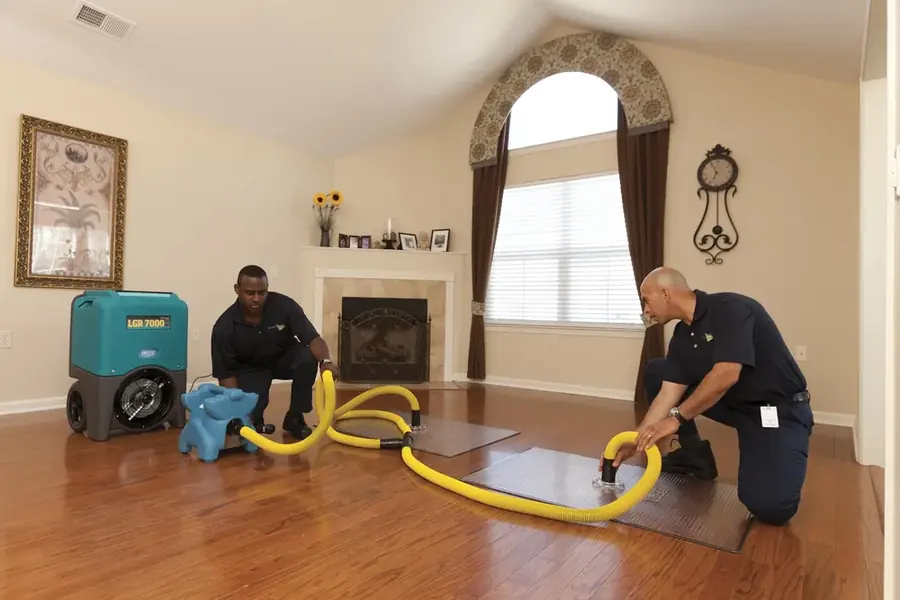 Technician extracting standing water from a Pasadena floor